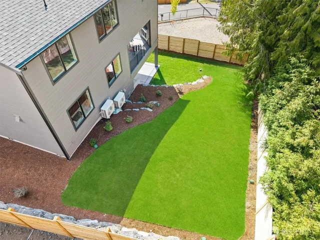 an aerial view of lake and residential houses with outdoor space