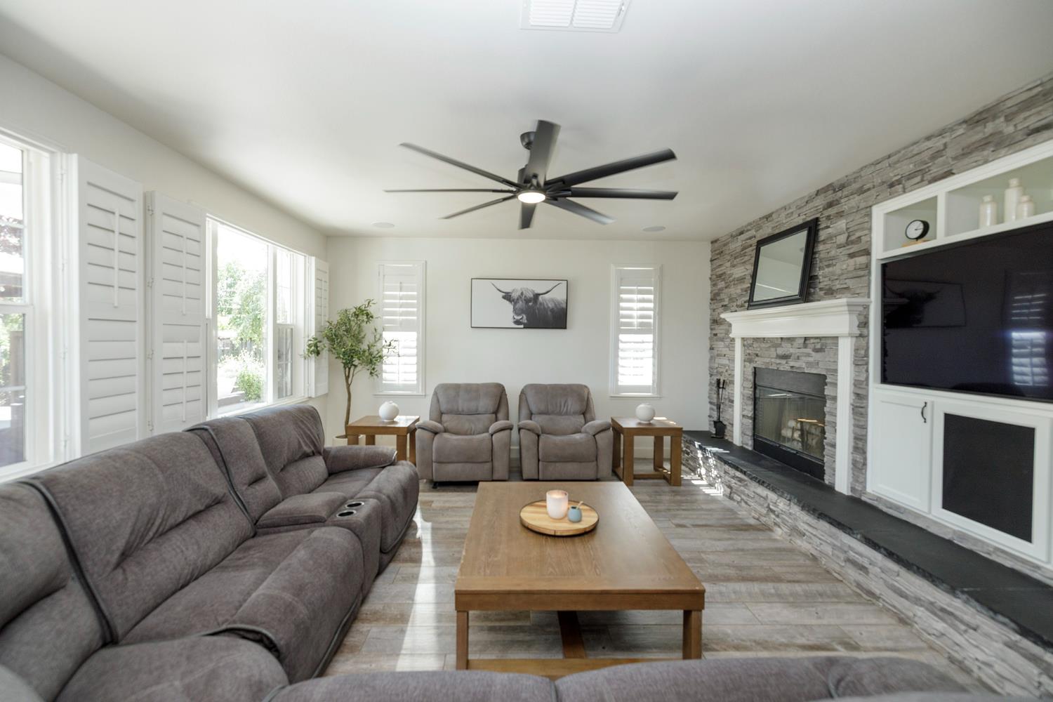 1682 Fairway Oaks Court Ripon, CA 95366 - Photo 12 of 51 a living room with furniture a fireplace and a flat screen tv