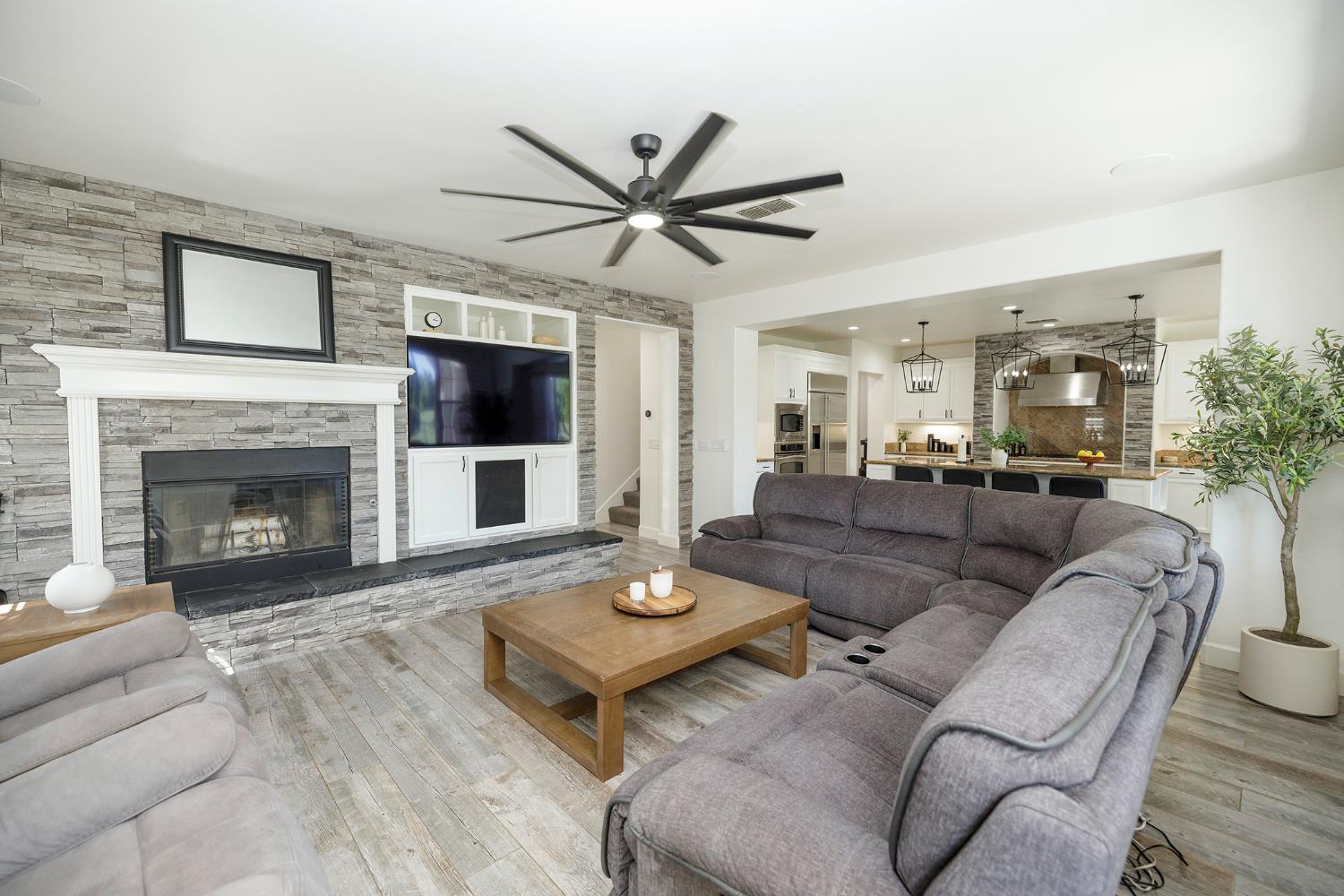 1682 Fairway Oaks Court Ripon, CA 95366 - Photo 14 of 51 a living room with furniture a flat screen tv and a fireplace