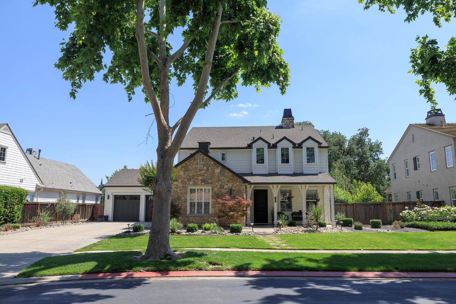 1682 Fairway Oaks Court Ripon, CA 95366 - Photo 50 of 51 a front view of a house with a garden and trees
