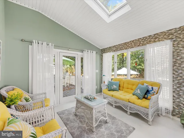 a dining room with furniture a rug and a large window