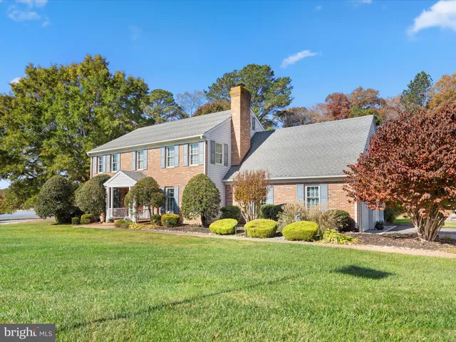 a kitchen with stainless steel appliances granite countertop a kitchen island a table and chairs in it