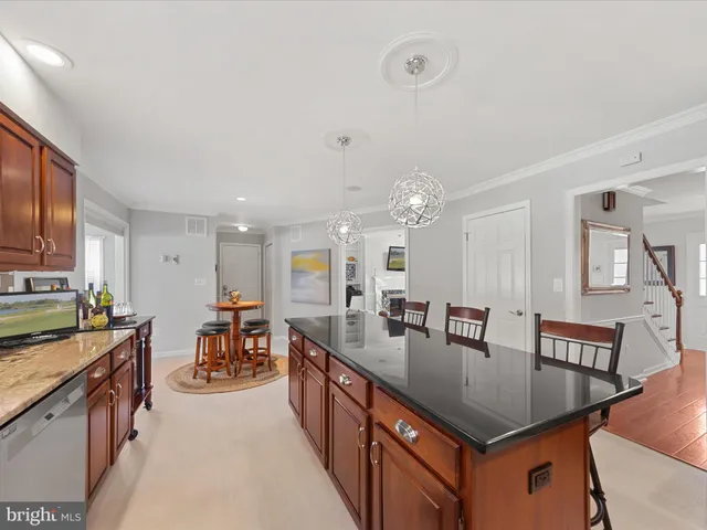 a kitchen with stainless steel appliances granite countertop sink stove top oven and cabinets