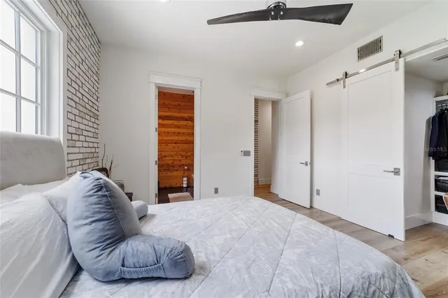 a view of a room with wooden floor and windows
