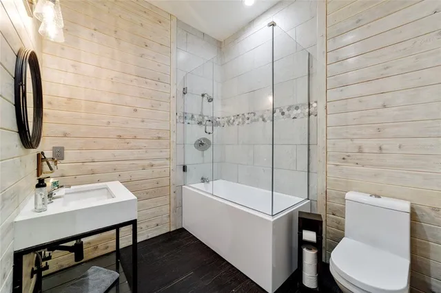 a large bathroom with a double vanity sink mirror and bathtub