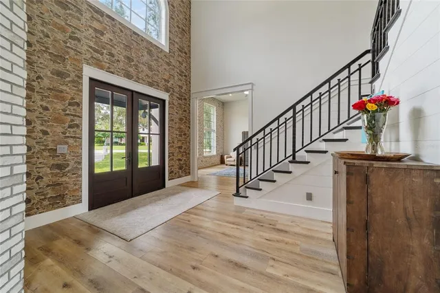 a view of staircase with lots of frames on wall and a window