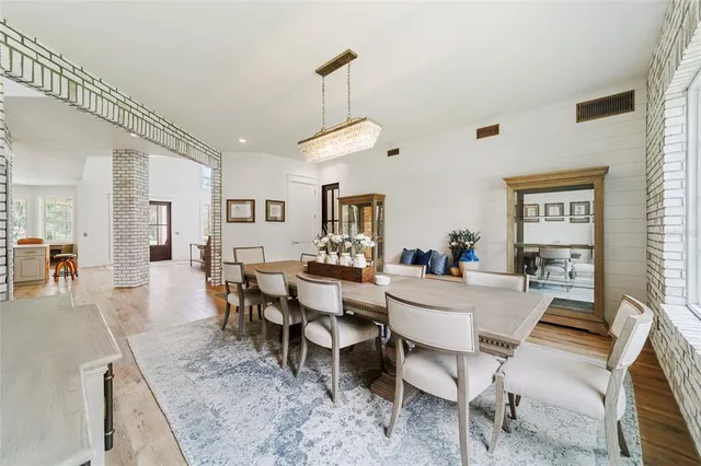 a living room with furniture a table and kitchen view