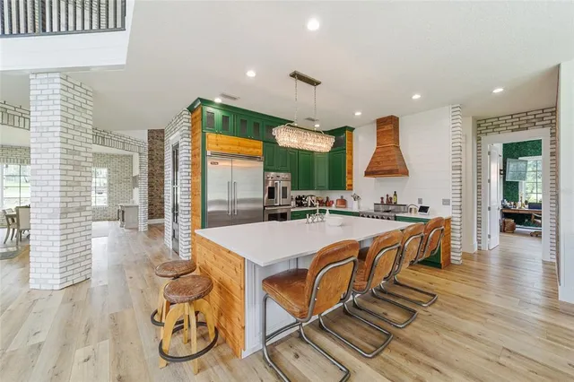 a living room with furniture and kitchen view