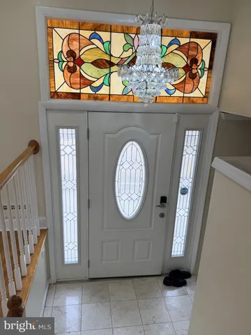 a kitchen with kitchen island granite countertop a sink a stove a oven a counter top and cabinets