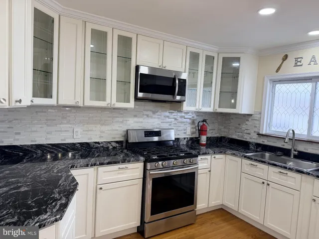 a view of a kitchen counter space and wooden floor