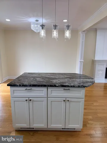 a view of a room with wooden floor and a window