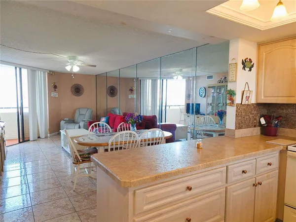 a view of a kitchen area with furniture and wooden floor