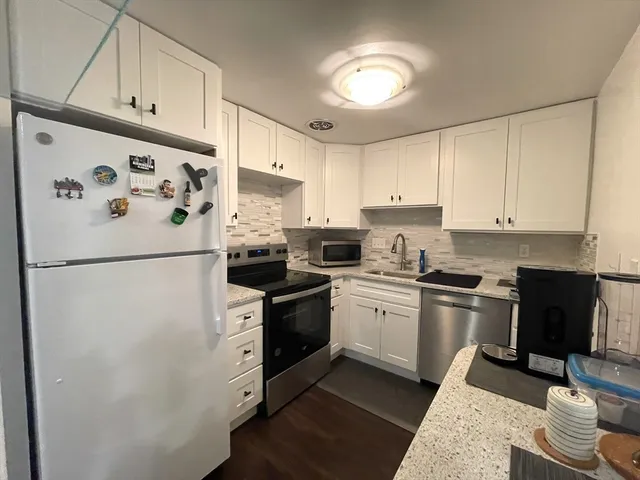 a white refrigerator freezer sitting inside of a kitchen