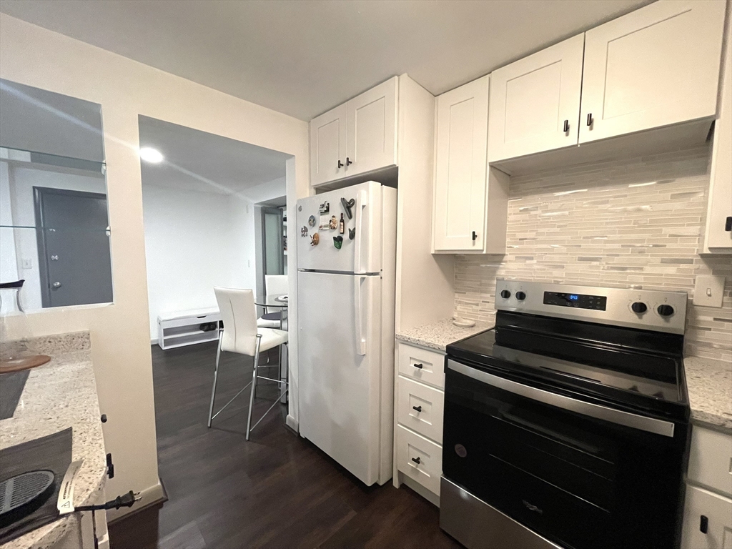 1325 Worcester Road, Unit C3 Framingham, MA 01701 - Photo 10 of 27 a kitchen with a refrigerator and a stove top oven
