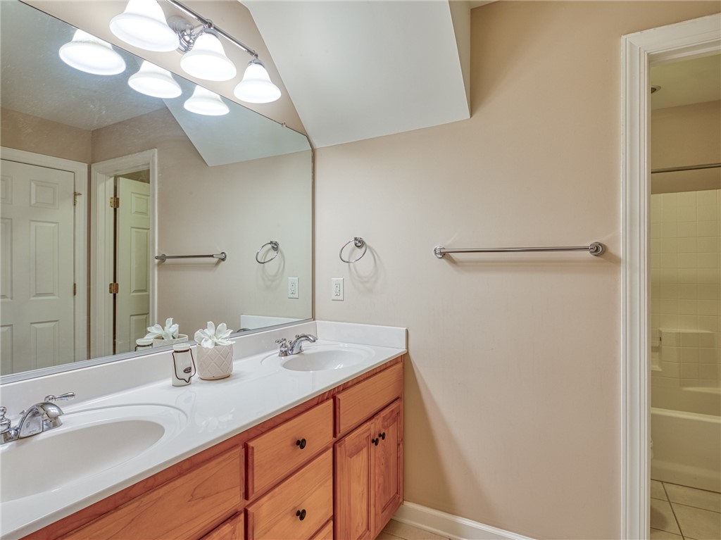 7914 O Neil Road Gloucester, VA 23061 - Photo 33 of 47 Bathroom featuring double vanity, light tile patterned flooring, and shower / bathtub combination