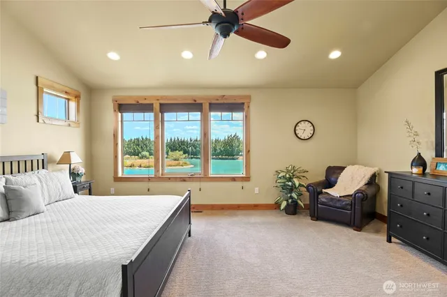 a spacious bedroom with a bed and a large window