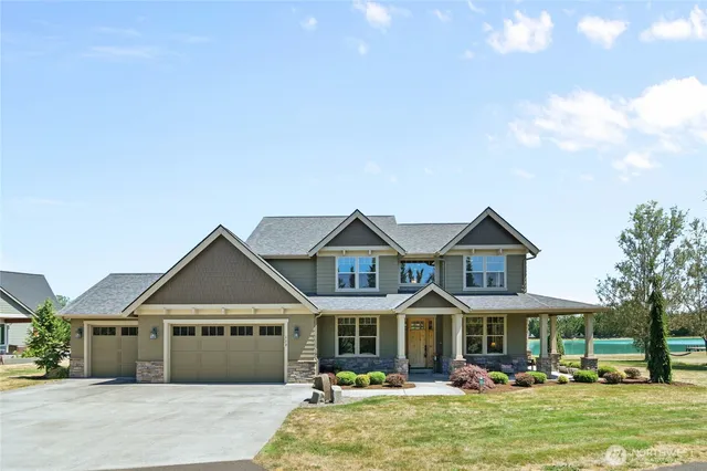 a front view of a residential apartment building with a yard