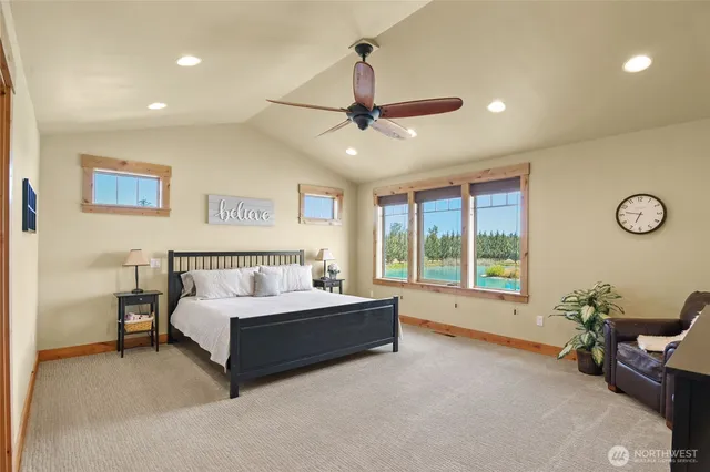 a spacious bedroom with a bed and a chandelier