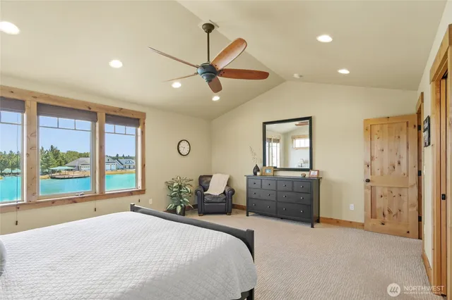 a bedroom with a bed and a large window