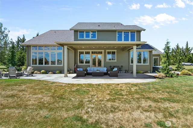 a view of a house with a yard patio and fire pit