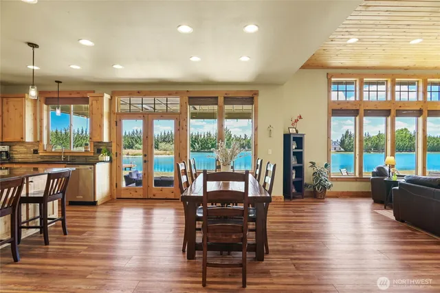 a living room with furniture and large windows