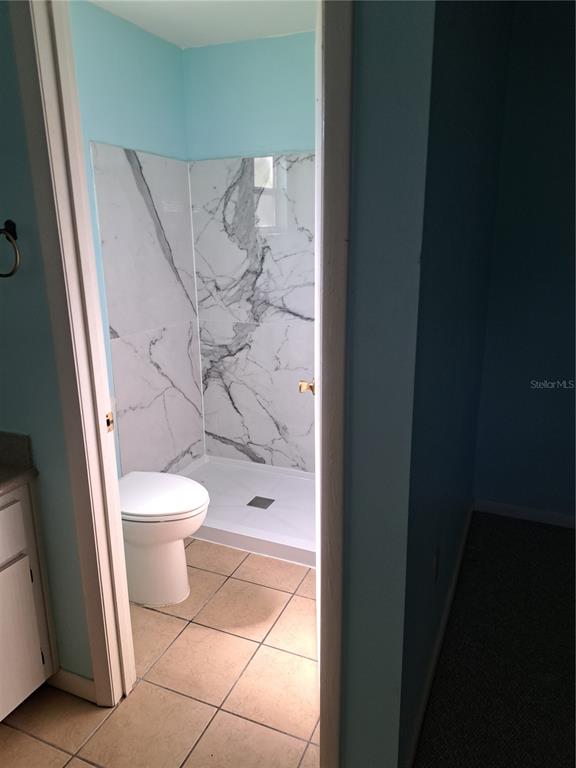 5618 Rosewall Circle Leesburg, FL 34748 - Photo 13 of 29 a white toilet sitting next to a bathroom sink and vanity