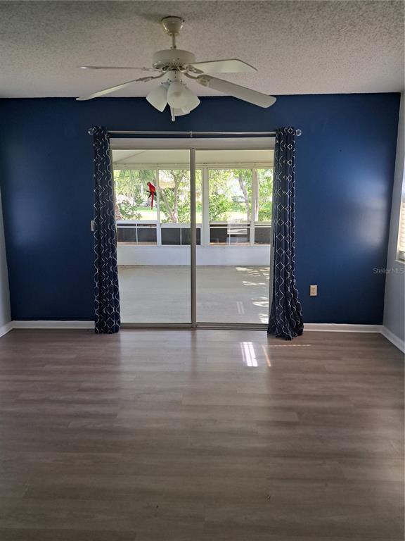 5618 Rosewall Circle Leesburg, FL 34748 - Photo 16 of 29 a view of an empty room with wooden floor and a window