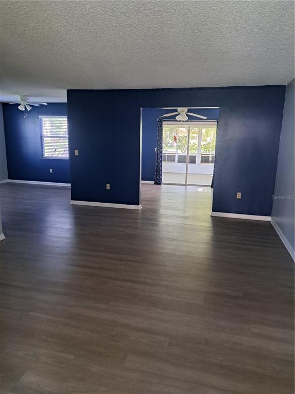 5618 Rosewall Circle Leesburg, FL 34748 - Photo 3 of 29 an empty room with wooden floor and windows