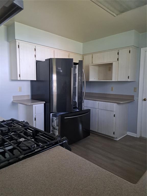 5618 Rosewall Circle Leesburg, FL 34748 - Photo 5 of 29 a kitchen with stainless steel appliances granite countertop a refrigerator and a stove