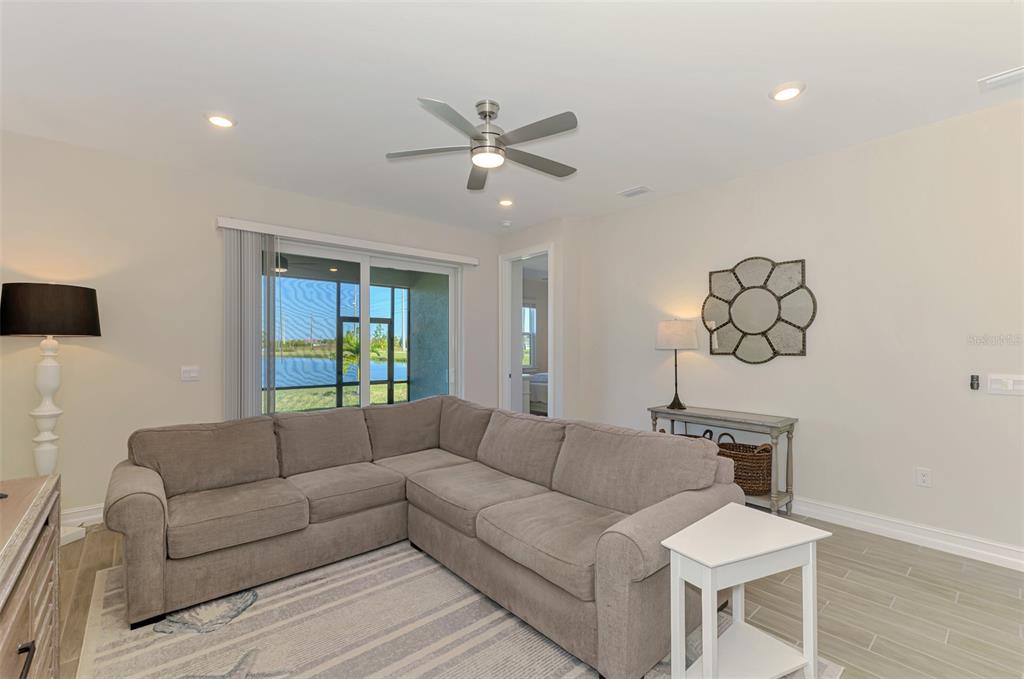 387 Ibiza Loop Venice, FL 34292 - Photo 12 of 60 a living room with furniture and a chandelier