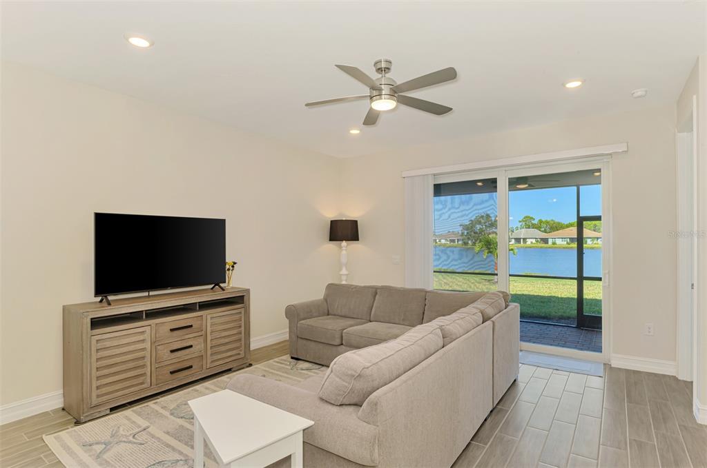 387 Ibiza Loop Venice, FL 34292 - Photo 13 of 60 a living room with furniture and a flat screen tv