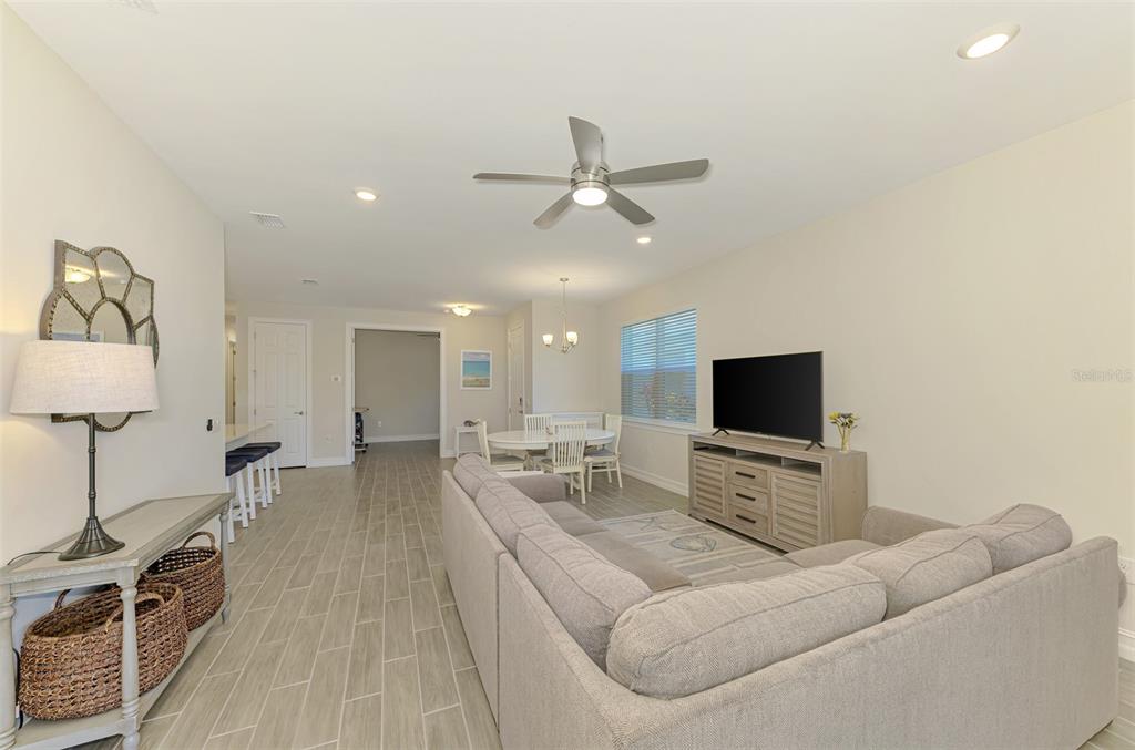 387 Ibiza Loop Venice, FL 34292 - Photo 14 of 60 a living room with furniture and a flat screen tv