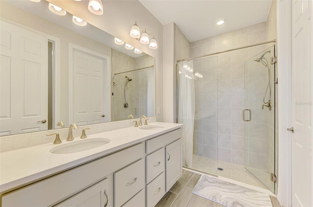 387 Ibiza Loop Venice, FL 34292 - Photo 25 of 60 a bathroom with a shower sink double and mirror