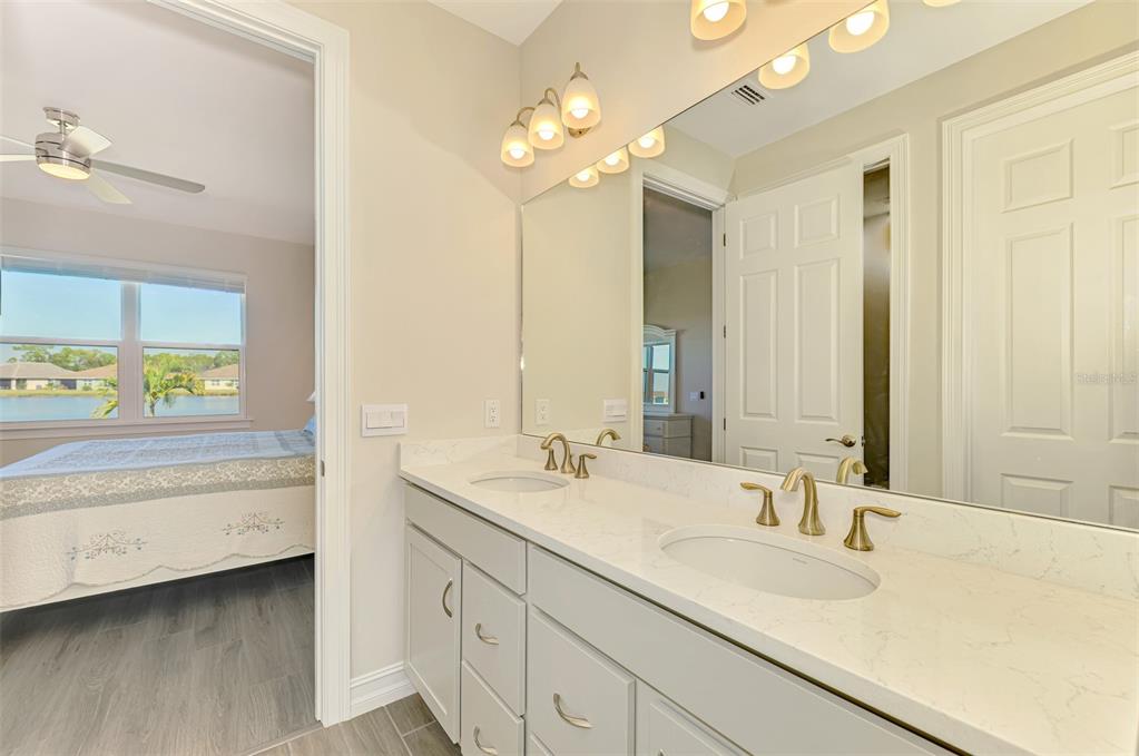 387 Ibiza Loop Venice, FL 34292 - Photo 26 of 60 a bathroom with a sink double vanity and a mirror