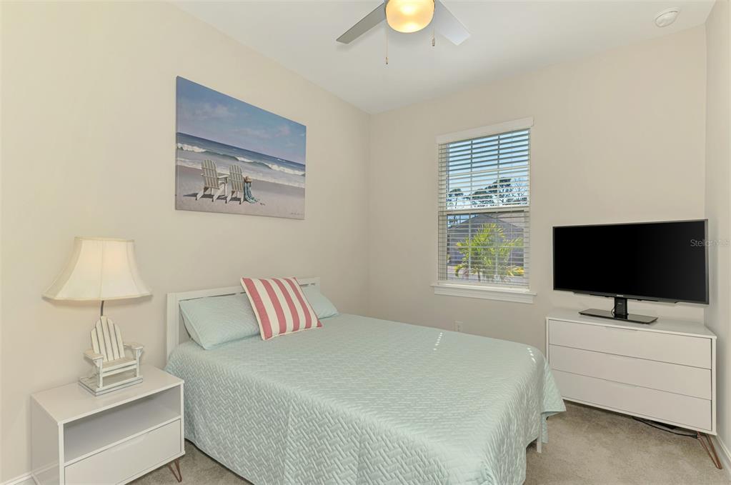 387 Ibiza Loop Venice, FL 34292 - Photo 27 of 60 a bedroom with a bed and a flat screen tv