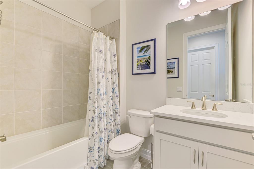 387 Ibiza Loop Venice, FL 34292 - Photo 29 of 60 a bathroom with a sink toilet and shower