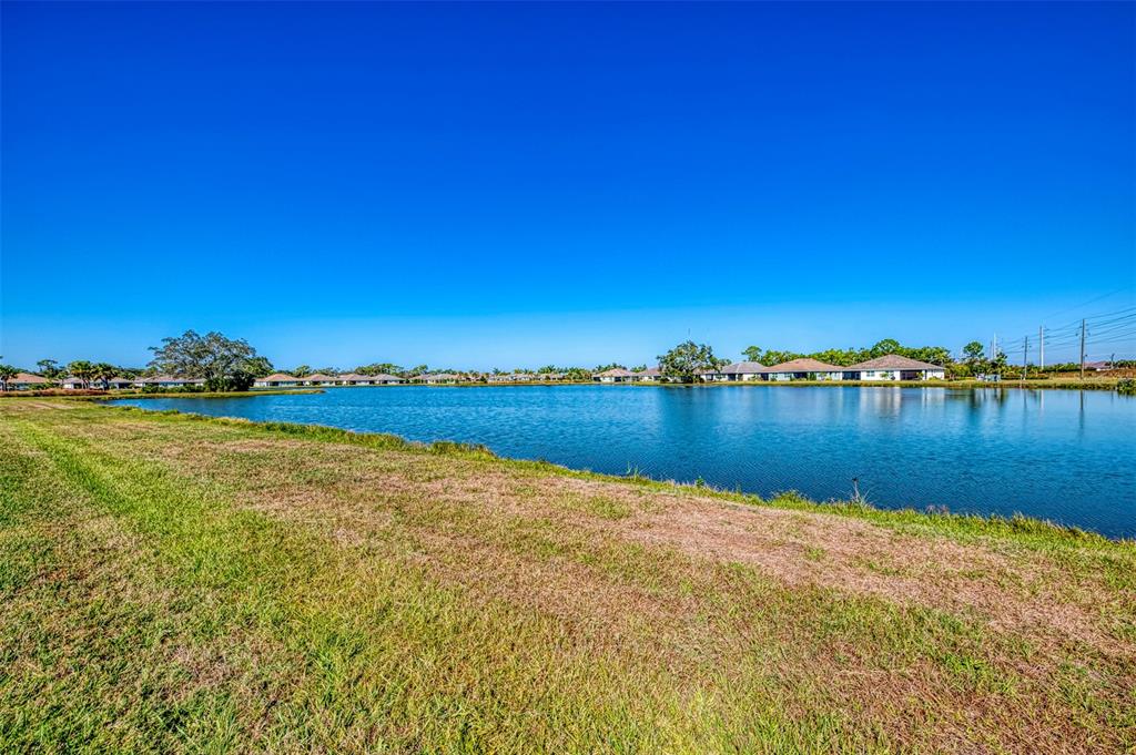 387 Ibiza Loop Venice, FL 34292 - Photo 37 of 60 a view of a lake with houses in the background