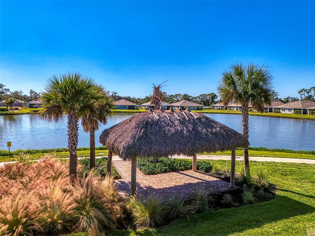 387 Ibiza Loop Venice, FL 34292 - Photo 45 of 60 a view of yard with outdoor seating and lake