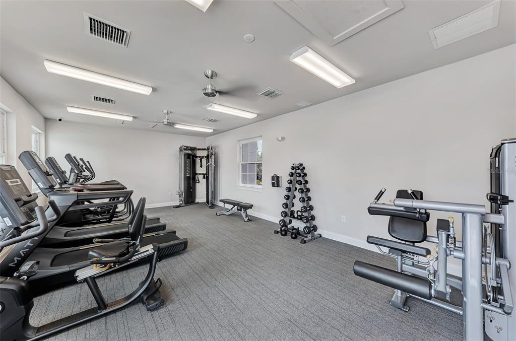 387 Ibiza Loop Venice, FL 34292 - Photo 46 of 60 a room with gym equipment and wooden floor