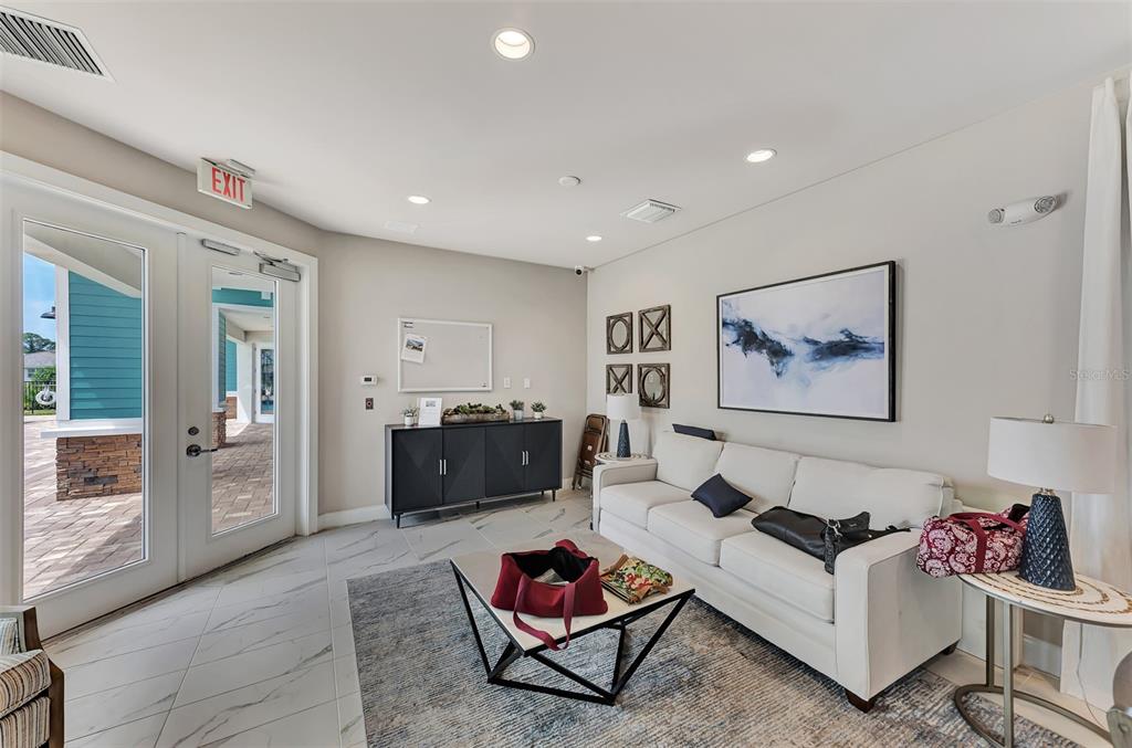 387 Ibiza Loop Venice, FL 34292 - Photo 47 of 60 a living room with furniture a rug and a painting on the wall
