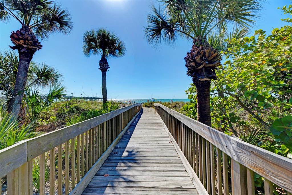 387 Ibiza Loop Venice, FL 34292 - Photo 58 of 60 a view of balcony with wooden fence and palm trees
