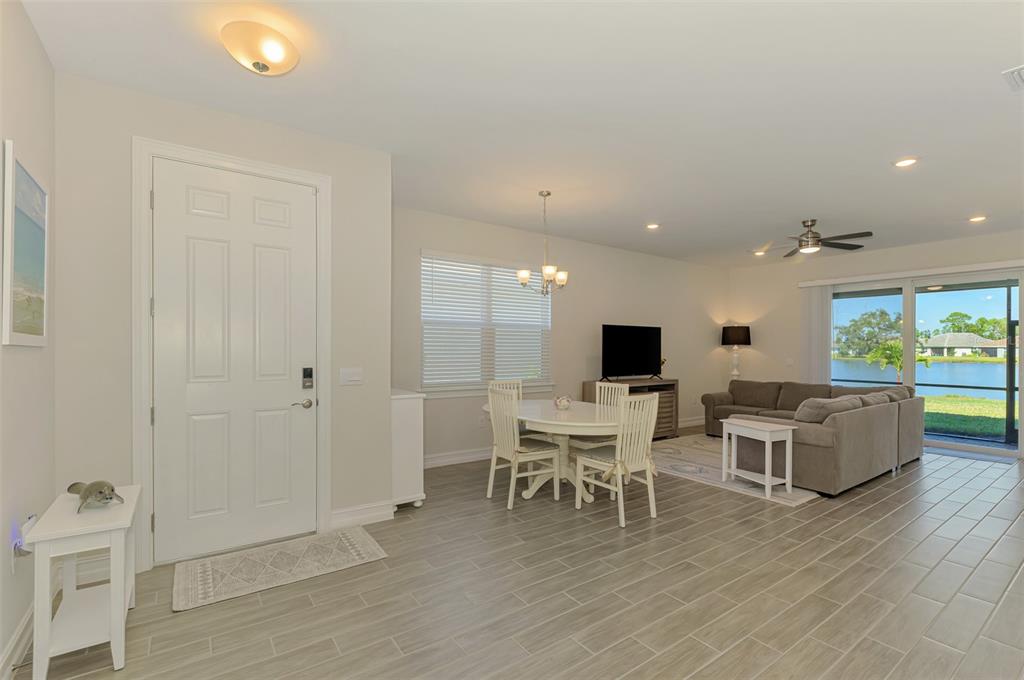 387 Ibiza Loop Venice, FL 34292 - Photo 9 of 60 a living room with furniture wooden floor and a flat screen tv