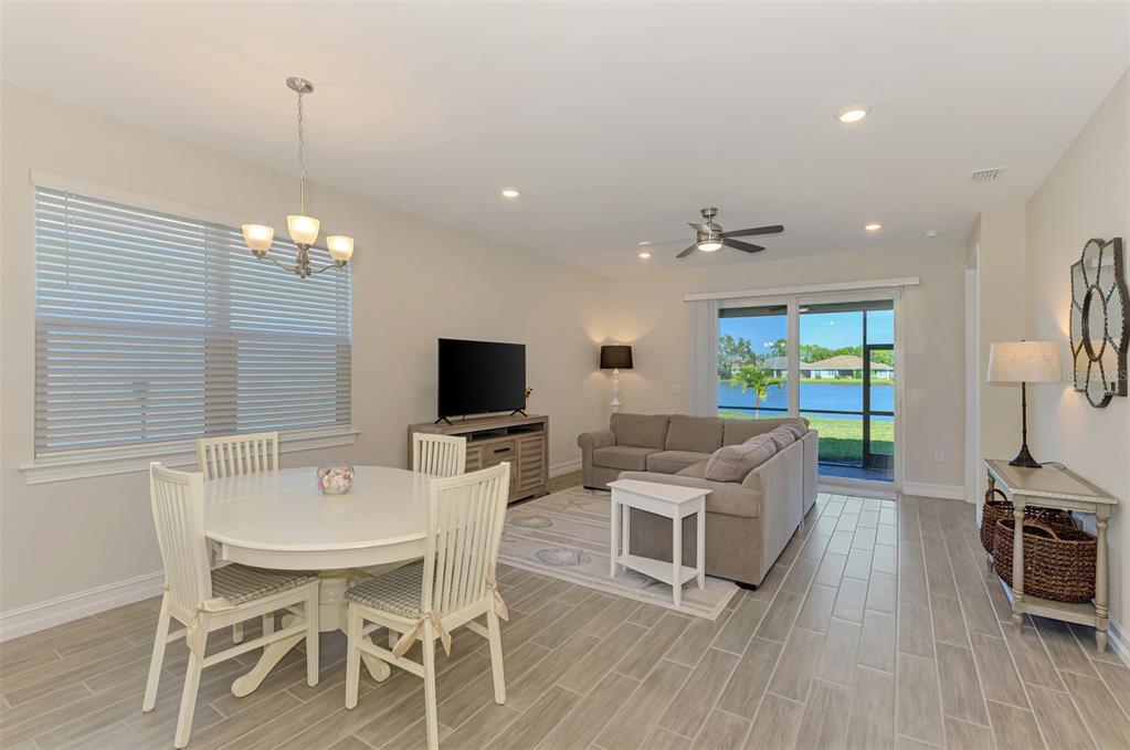 387 Ibiza Loop Venice, FL 34292 - Photo 10 of 60 a living room with furniture a flat screen tv and kitchen view