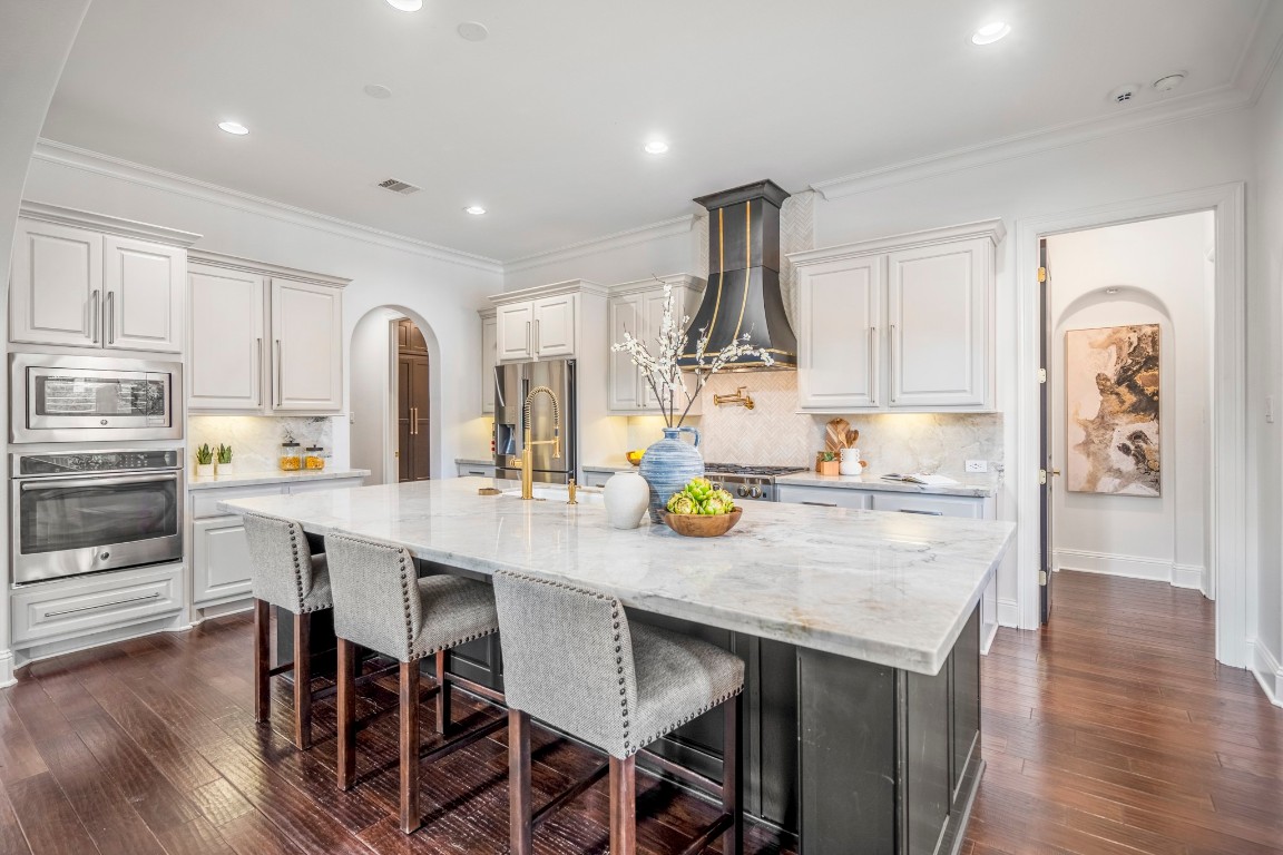 39 Beacons Light Place Tomball, TX 77375 - Photo 18 of 50 a kitchen with a table chairs microwave and cabinets