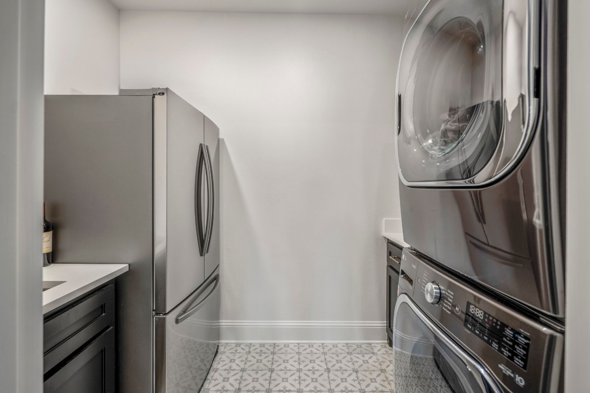 39 Beacons Light Place Tomball, TX 77375 - Photo 21 of 50 Laundry room fits full size washer and dryer stacked, full size refrigerator, countertop & cabinets for folding and storage, as well as a laundry room sink.