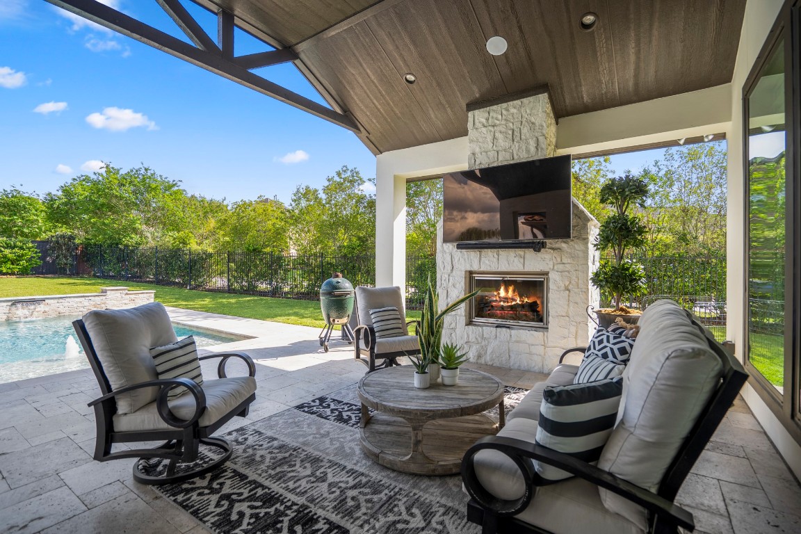 39 Beacons Light Place Tomball, TX 77375 - Photo 40 of 50 Covered back patio and fireplace with sound speakers that connect to main home system.