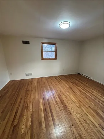 a view of a room with wooden floor