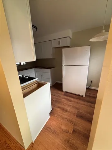 a kitchen with a refrigerator sink stove and cabinets