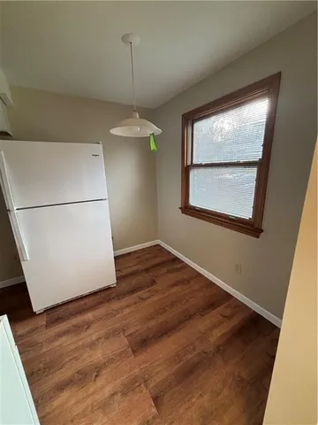 a view of a room with wooden floor and a window