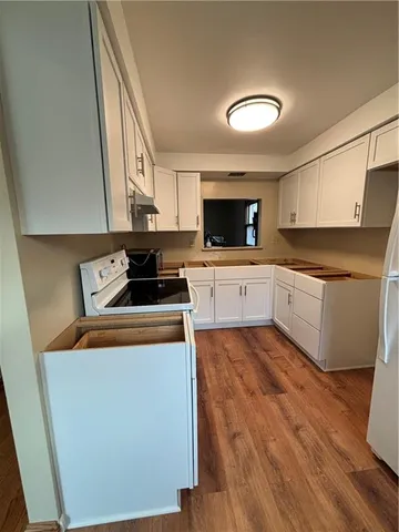 a kitchen with a stove a sink and a microwave